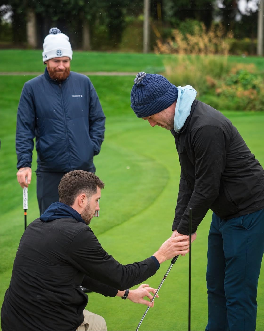 Shane helping a student with grip and setup